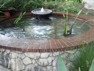 Pond construction: round brick and rock pond